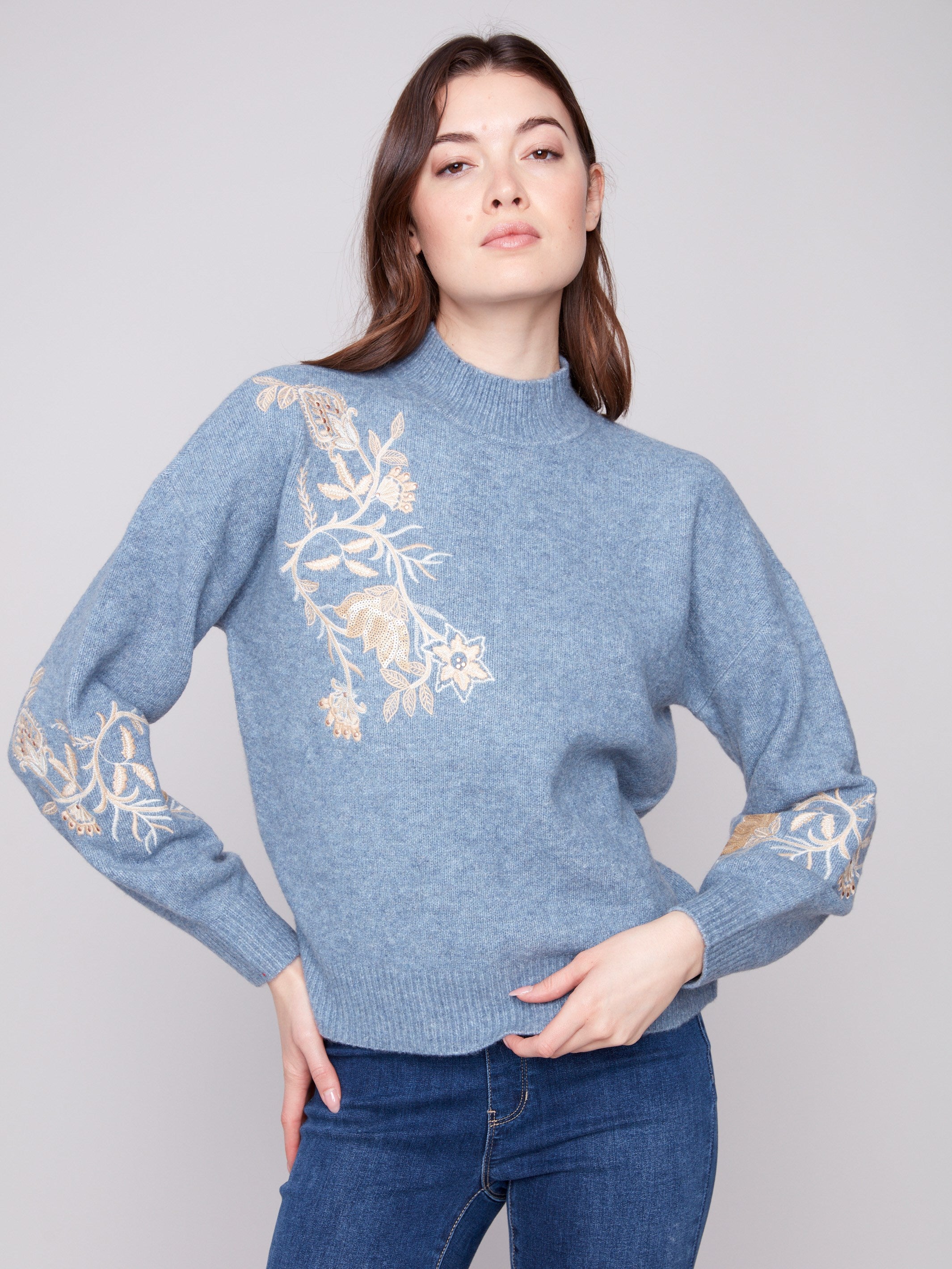 Denim sweater featuring elegant drop shoulders and intricate floral embroidery with sequins, perfect for a chic look by Charlie B.