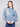 Elegant heather denim sweater adorned with delicate embroidered flowers and shimmering sequins, complete with drop shoulders by Charlie B.