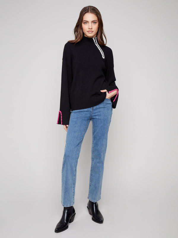 Elegant black sweater with open sleeve cuffs for added flair by Charlie B.