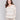 Beige sweater with a rounded V-neck and drop shoulders by Charlie B.