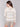 Beige striped sweater showcasing drop shoulder style by Charlie B.