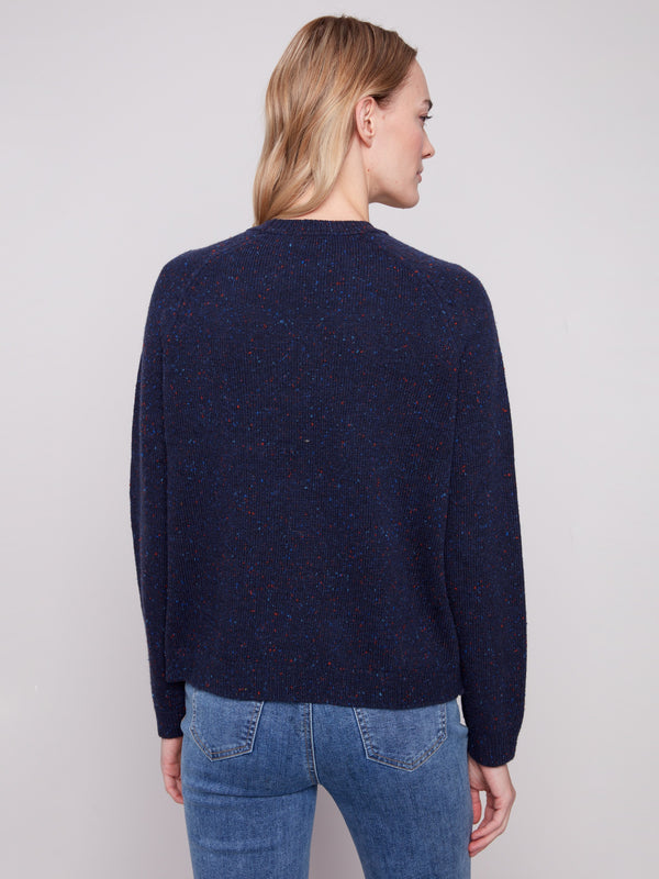Flecked yarn enhances this heather navy sweater with raglan sleeves and chic 'amour' design by Charlie B.