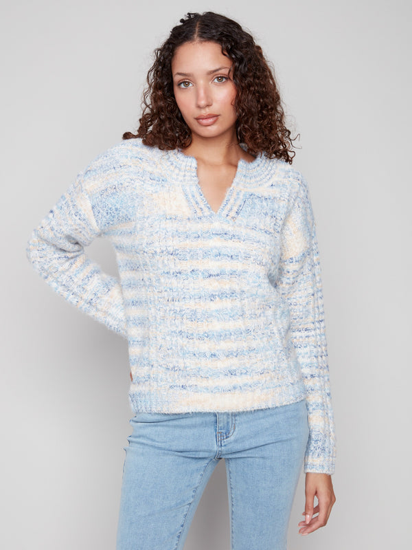 Denim-colored sweater featuring a cozy eyelash yarn material, perfect for chilly days with its soft texture by Charlie B.
