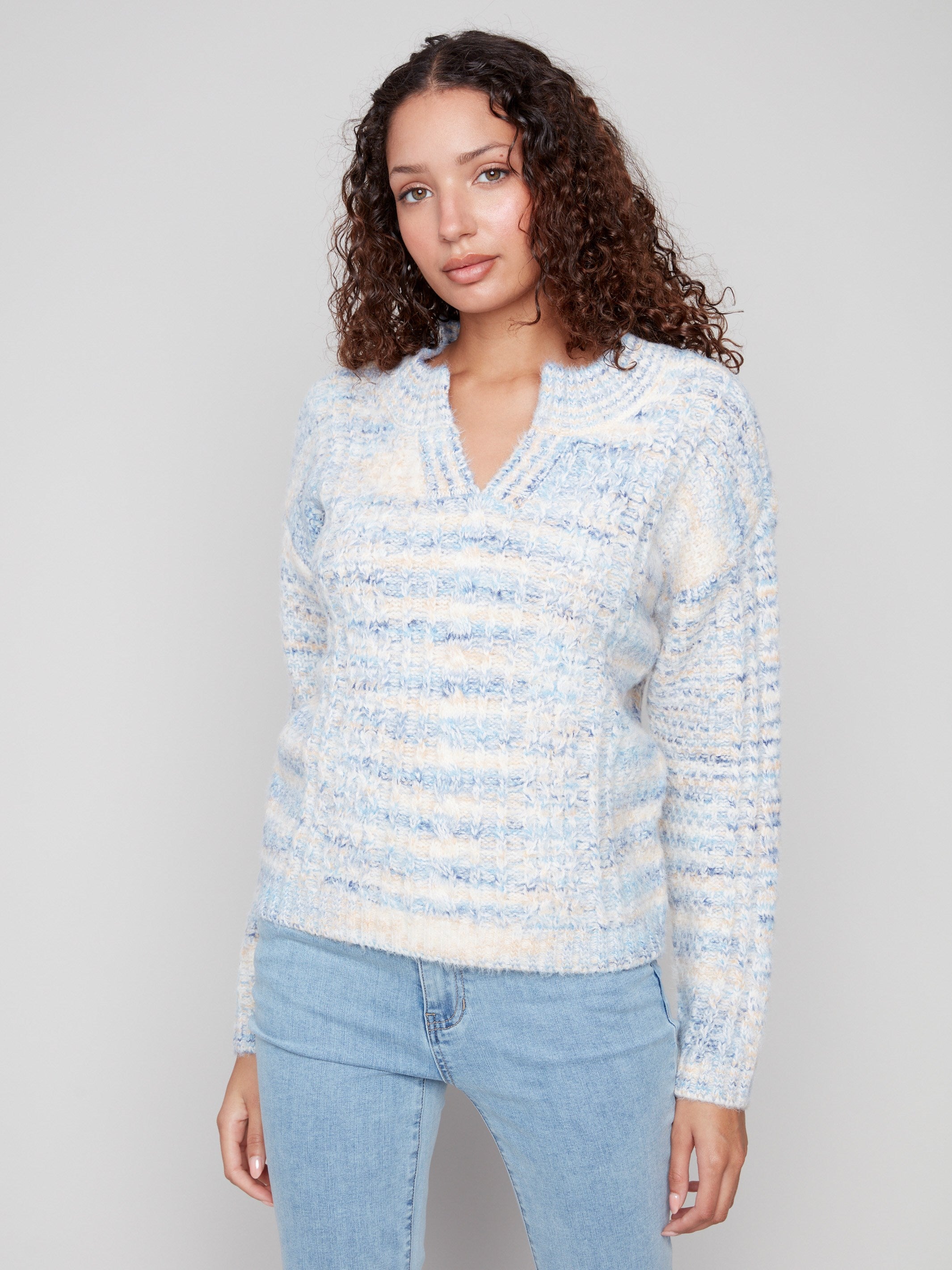 Cable knit sweater in denim color showcasing an elegant notched neckline for added style by Charlie B.