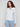 Cable knit sweater in denim color showcasing an elegant notched neckline for added style by Charlie B.