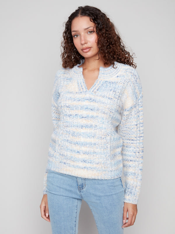 Cable knit sweater in denim color showcasing an elegant notched neckline for added style by Charlie B.