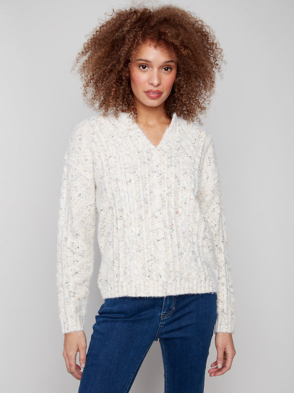 Ecru cable knit sweater crafted with eyelash yarn for a soft touch by Charlie B.