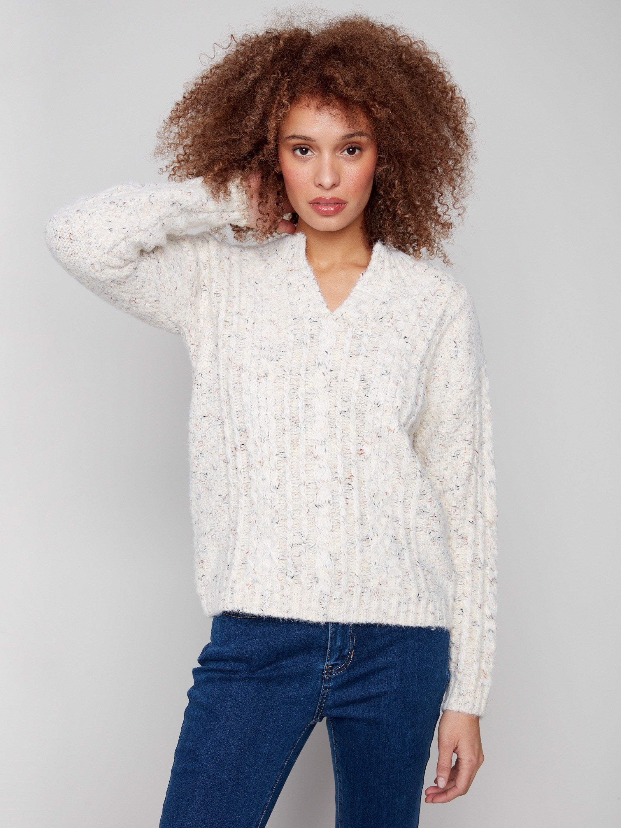 Ecru sweater featuring drop shoulder design and striped pattern by Charlie B.