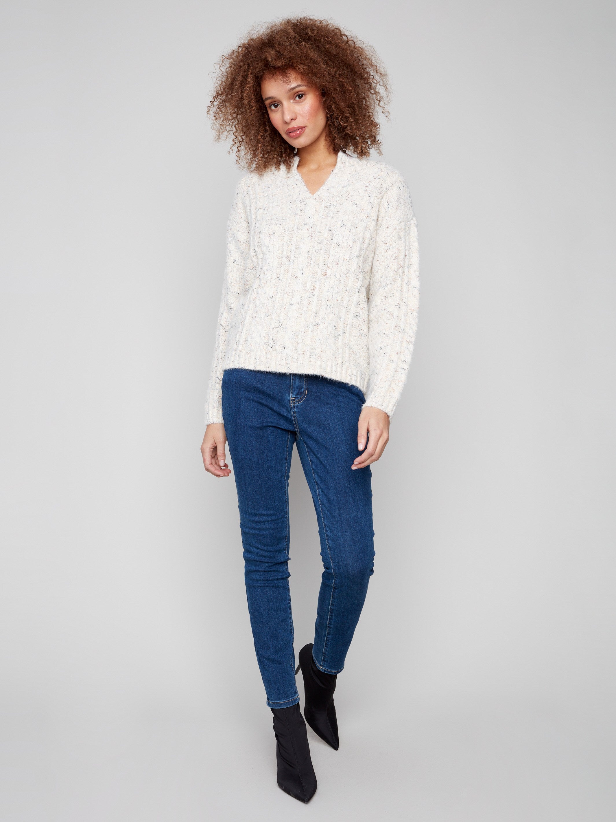 Cable knit sweater in ecru with luxurious eyelash yarn texture by Charlie B.
