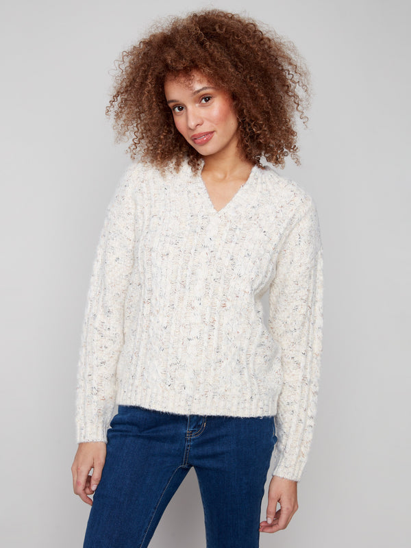 Elegant cable knit sweater in ecru, showcasing an eyelash yarn finish by Charlie B.
