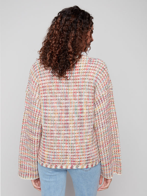 Fashionable crochet sweater in multicolor, highlighting the creative use of novelty yarn in its design by Charlie B.