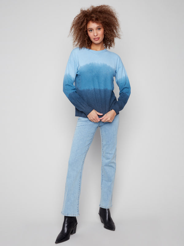 This blue ombre sweater features long sleeves that provide warmth and style, enhanced by an artistic gradient by Charlie B.