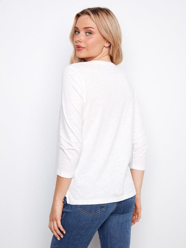 Elegant white top showcasing a classic crew neckline in organic cotton, by Charlie B.