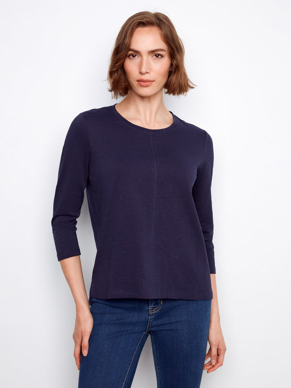 Elegant top featuring a classic crew neckline, perfect for casual outings. Designed for comfort and style by Charlie B.