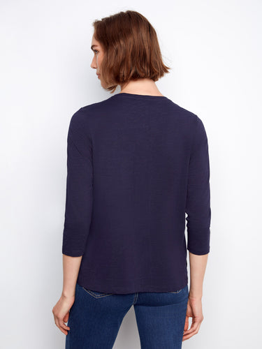 Stylish top with a slit hem design, offering ease of movement and modern flair. Fashionably created by Charlie B.