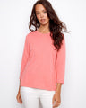 Soft pink top featuring a classic crew neckline, adding timeless style to any outfit. By Charlie B.