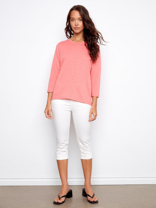 Chic design with front seam detail enhances this pink top's modern look. Perfect for versatile styling. By Charlie B.