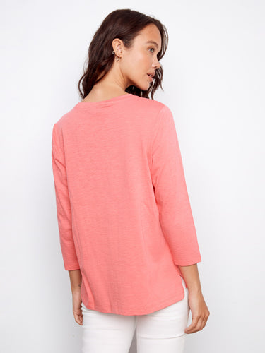 Elegant slit hem adds a touch of flair to this charming pink top, perfect for layering or solo wear. By Charlie B.