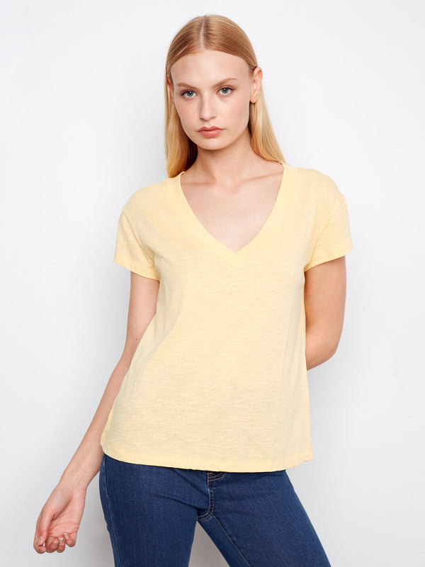 This yellow t-shirt features a flattering V-neck, perfect for casual outings. Made with lightweight cotton for comfort. By Charlie B.