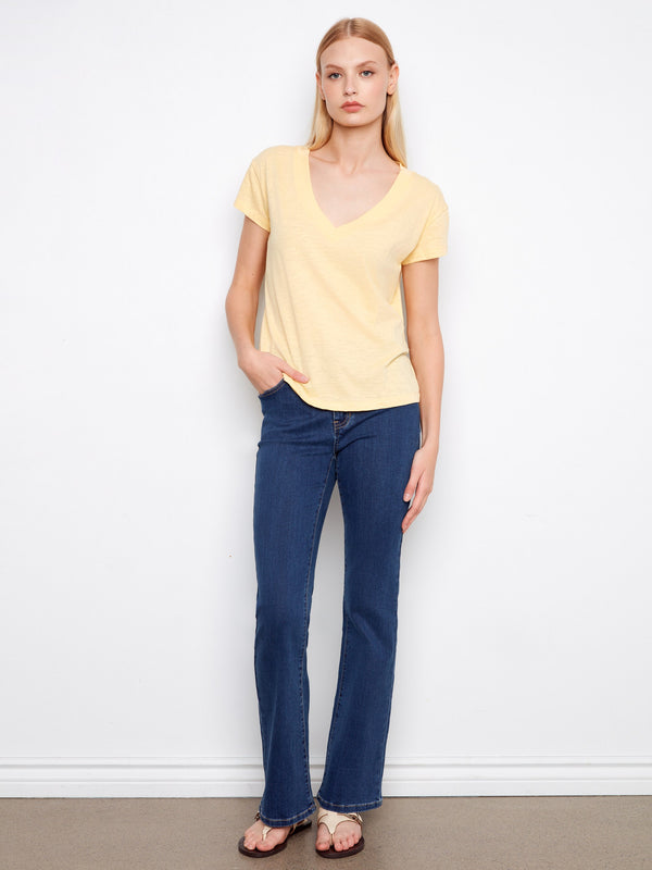 Experience the relaxed fit of this yellow tee with its drop shoulder design, offering effortless style and ease. By Charlie B.