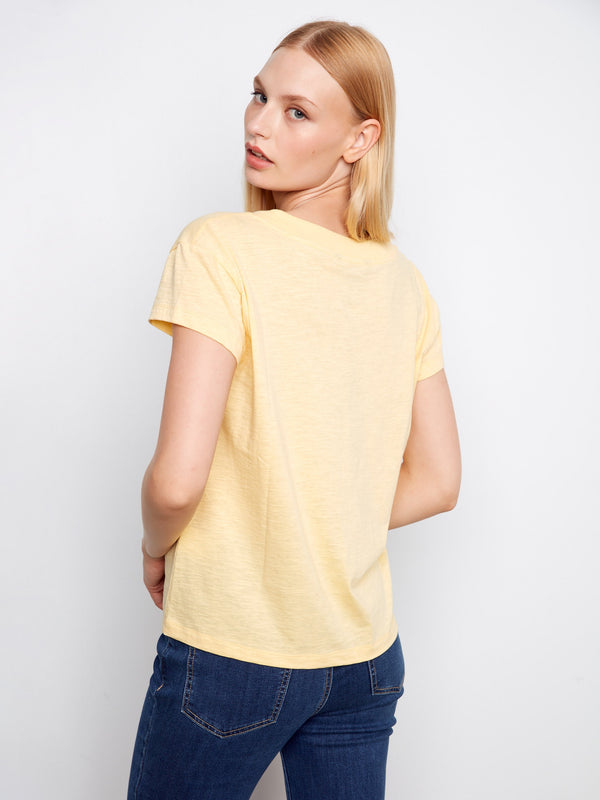The drop shoulder design of this yellow t-shirt adds a contemporary touch to your everyday wardrobe essentials. By Charlie B.
