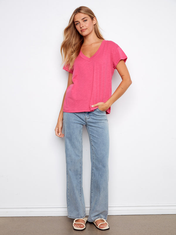 Casual pink top with a flattering V-neck and drop shoulder design. Crafted from lightweight cotton for comfort by Charlie B.
