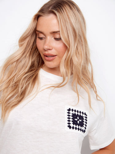 Elevate your wardrobe with this 100% cotton tee, showcasing a unique crochet pocket design by Charlie B.
