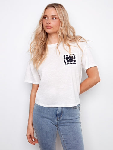 Experience comfort and style with this white tee, crafted from pure cotton and featuring a chic crochet pocket by Charlie B.