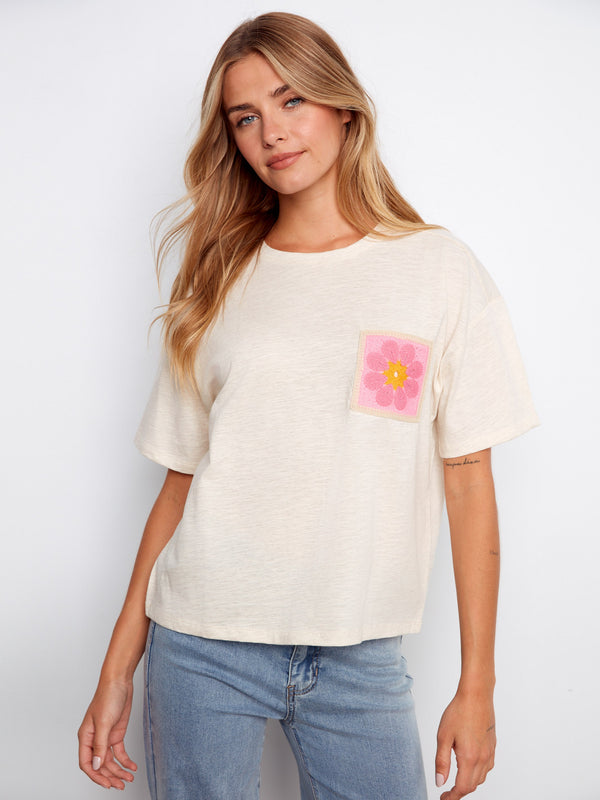 This beige top features a stylish crew neckline, making it a versatile piece for any wardrobe. Crafted by Charlie B.
