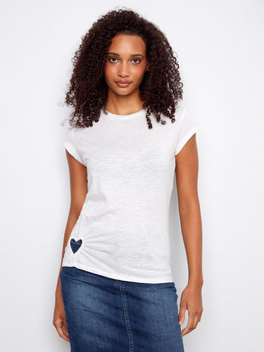 Crafted from 100% cotton, this white top offers comfort and breathability for everyday wear. Designed by Charlie B.