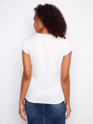 This elegant white top combines simplicity with style, making it a wardrobe essential for any occasion. Styled by Charlie B.