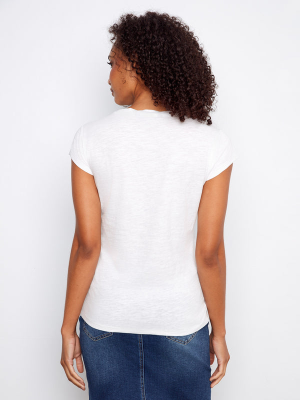 This elegant white top combines simplicity with style, making it a wardrobe essential for any occasion. Styled by Charlie B.