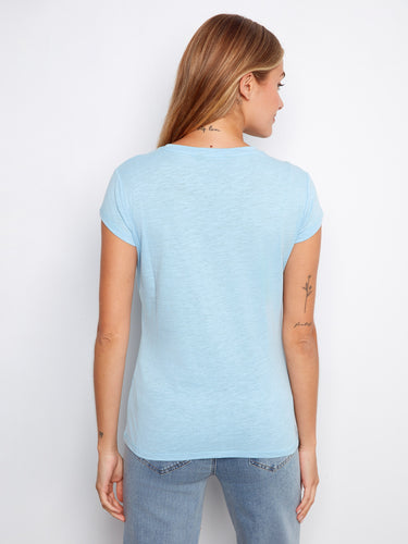 Crafted from 100% cotton, this light blue top offers both comfort and durability for everyday wear. Designed by Charlie B.