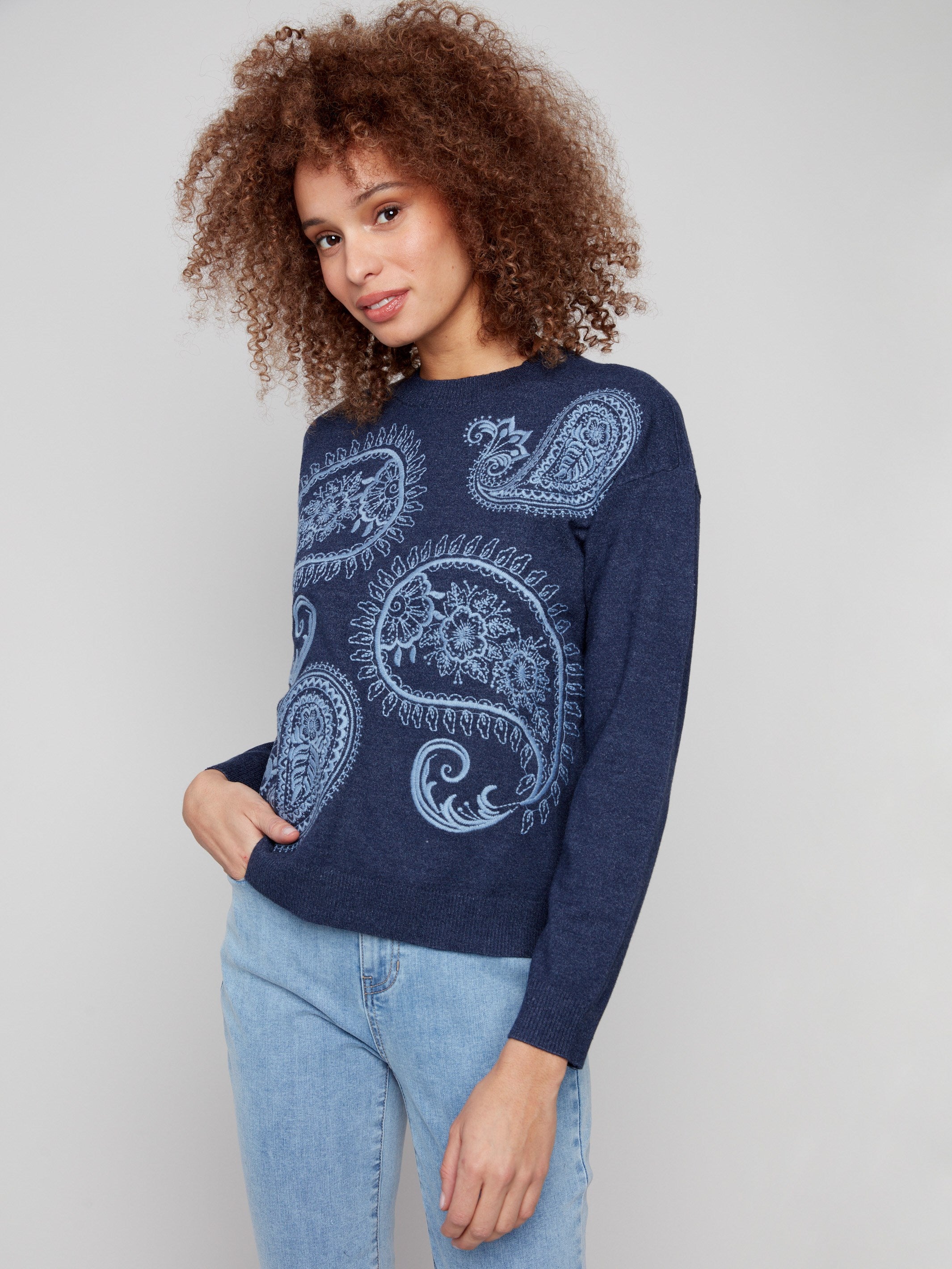 Paisley embroidery adorns this relaxed fit crew neck sweater in heather denim by Charlie B.