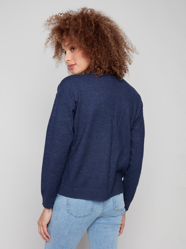 Ribbed cuffs add a touch of detail to this elegant heather denim paisley embroidered sweater by Charlie B.