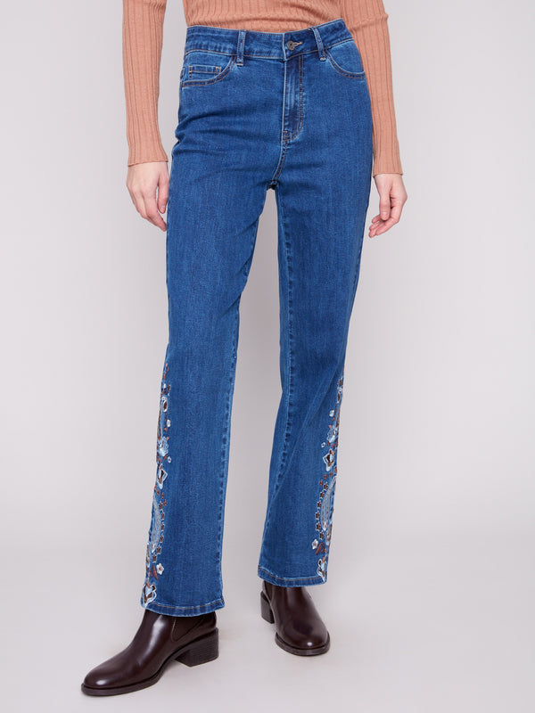 These indigo jeans boast a five-pocket design with intricate paisley embroidery detailing by Charlie B.