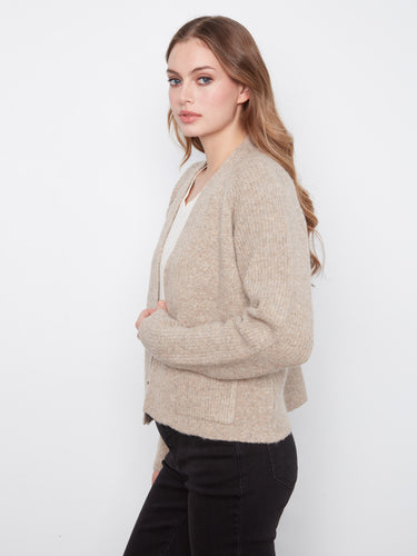 Warm cardigan with convenient patch pockets, ideal for keeping essentials close at hand. A versatile piece by Charlie B.