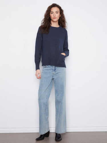 This stylish navy sweater features convenient side slits, adding a touch of flair to your wardrobe essentials. By Charlie B.
