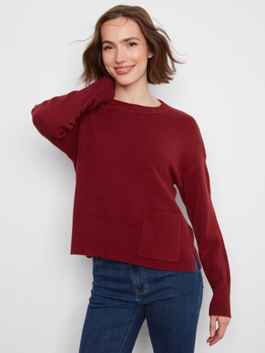 This red sweater showcases stylish side slits, adding a modern touch to the timeless crew neck look by Charlie B.