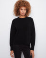 Black sweater with a crew neck and side slits, featuring a patch pocket for added style by Charlie B.
