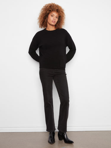 Elegant black sweater showcasing drop shoulders and a comfortable fit with a patch pocket by Charlie B.