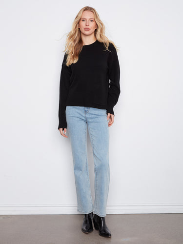 Sophisticated black sweater emphasizing its drop shoulders and stylish crew neck, complete with side slits by Charlie B.