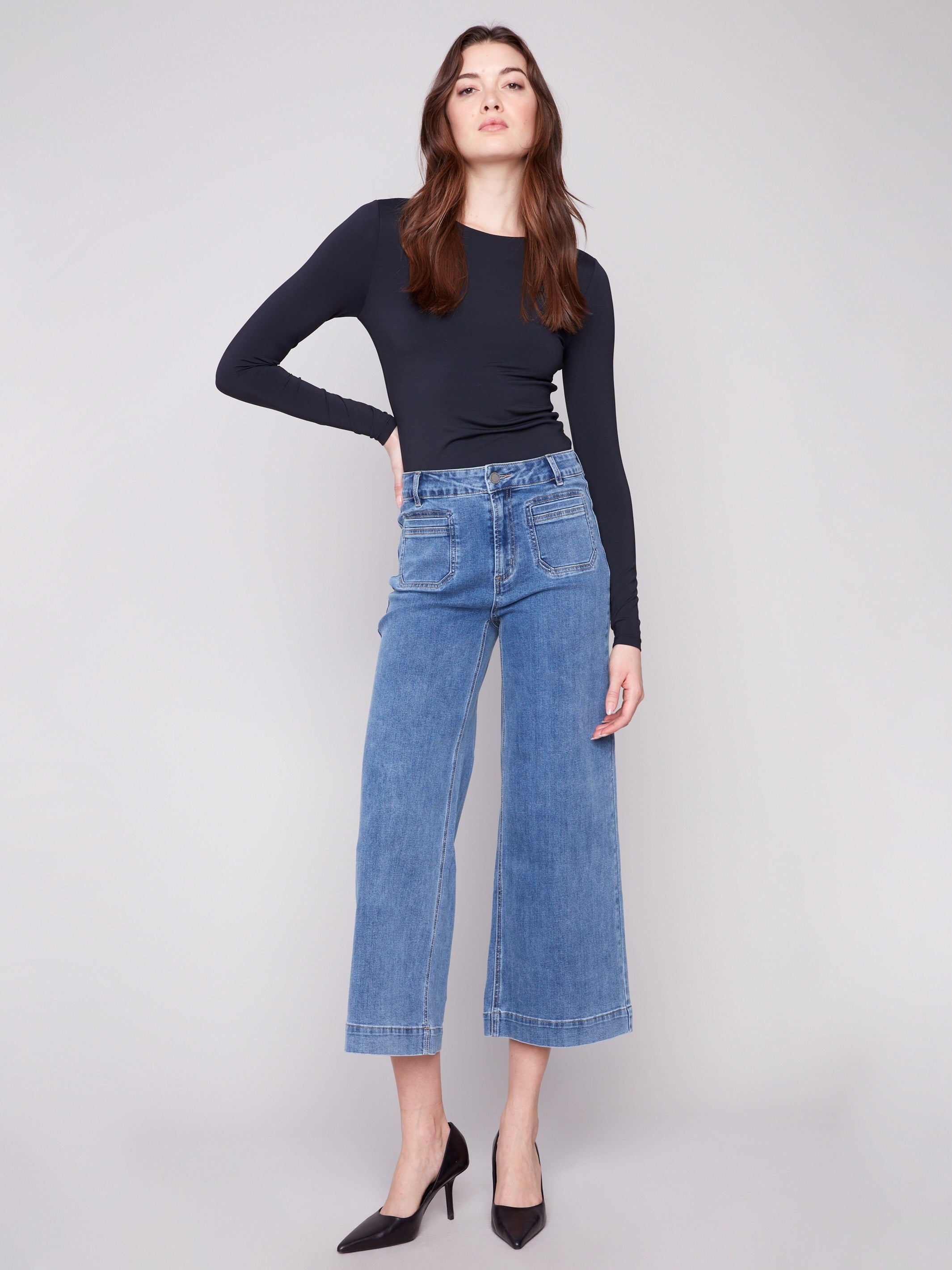 Stylish medium blue jeans with a flare fit and modern patch pockets, crafted from stretch denim for comfort by Charlie B.