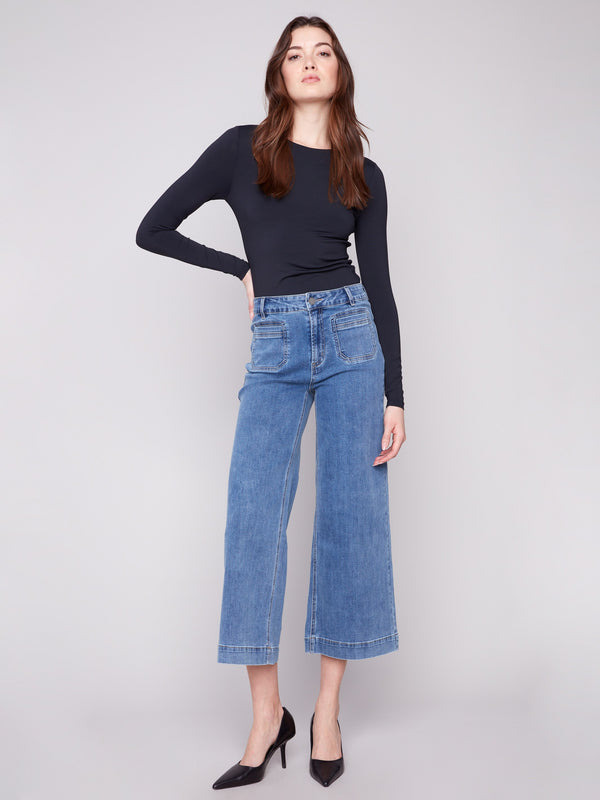 Stylish medium blue jeans with a flare fit and modern patch pockets, crafted from stretch denim for comfort by Charlie B.
