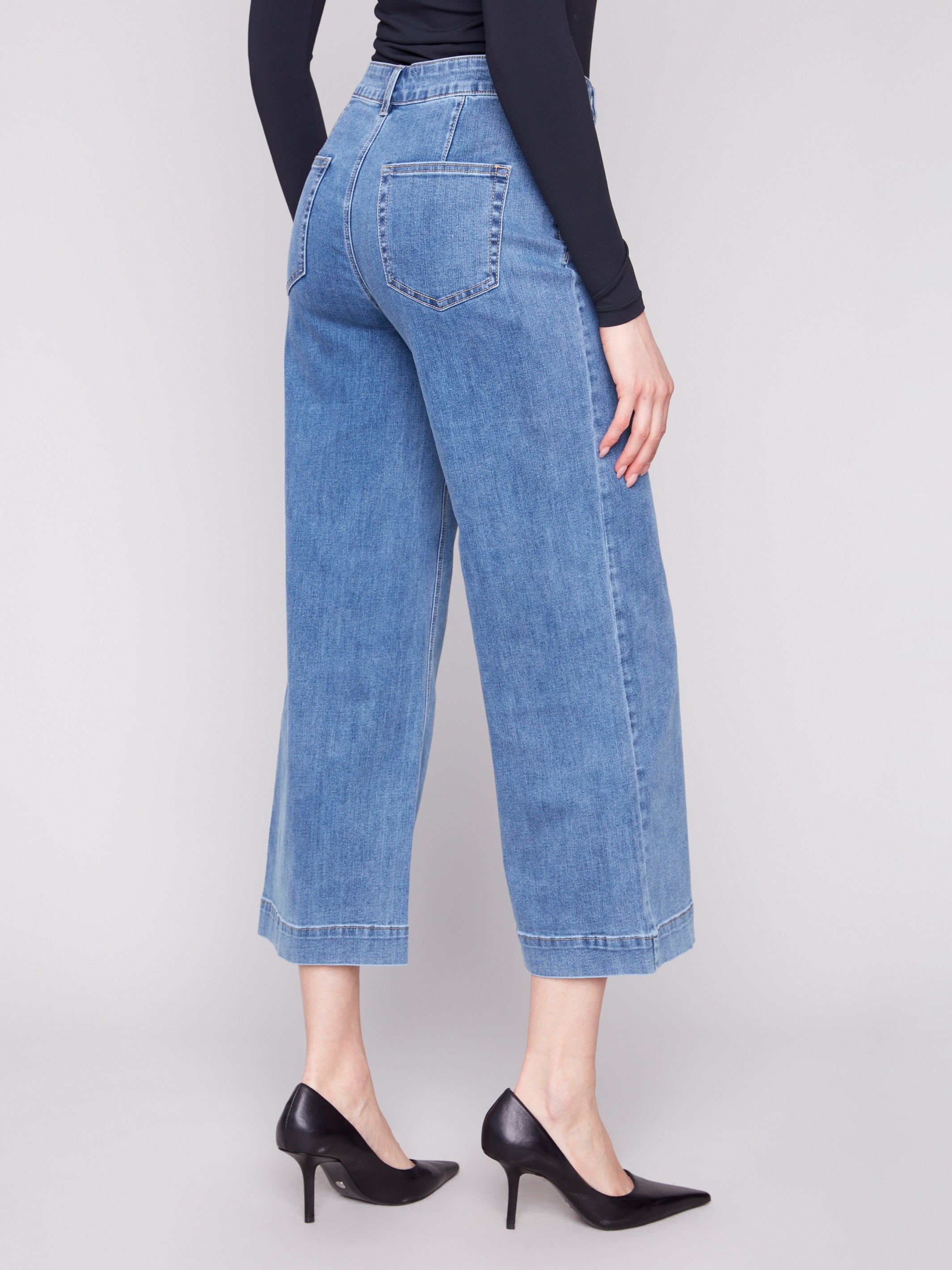 Comfortable stretch denim jeans in a regular rise, complete with functional back pockets for added practicality by Charlie B.