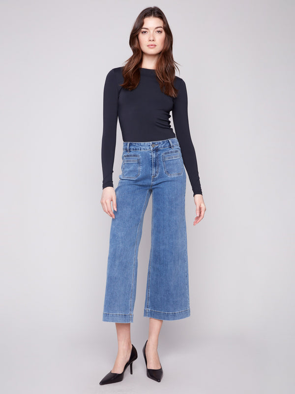 Medium blue cropped flare jeans with patch pockets, featuring a regular rise and modern fit by Charlie B.