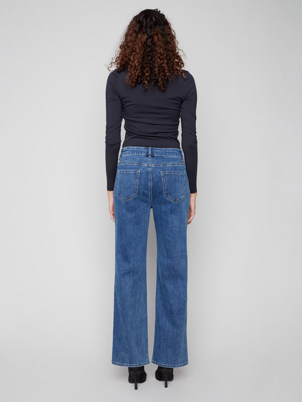 Back pockets enhance the practicality of these medium blue stretch denim jeans by Charlie B.