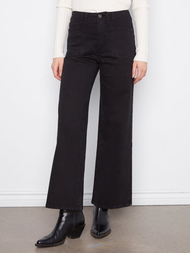 Full-length black wide-leg pants featuring patch pockets, styled with a white sweater by Charlie B.