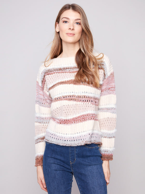 Cozy knit sweater featuring a classic crew neckline and stylish ribbed cuffs for added texture by Charlie B.