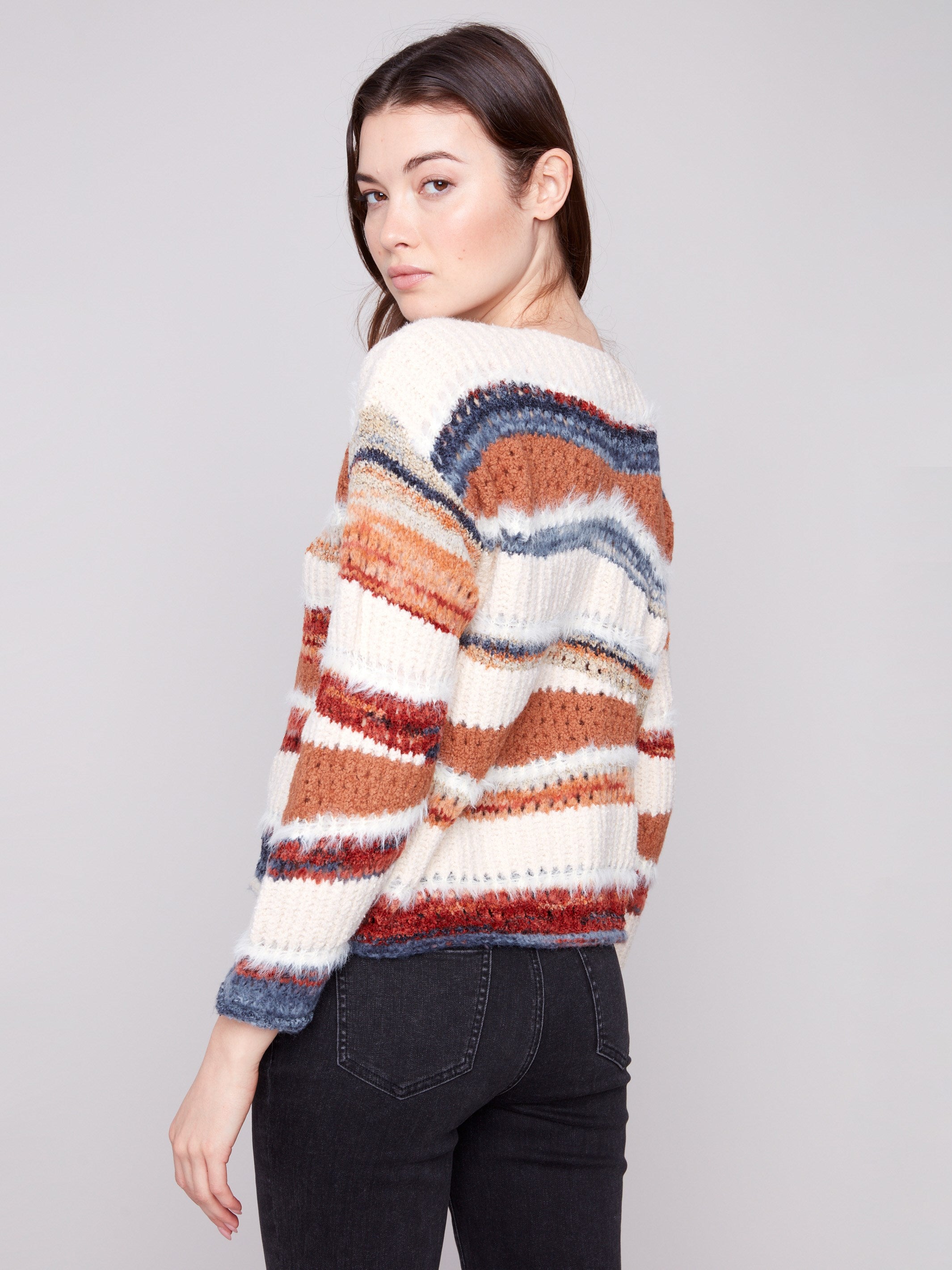 This unique patchwork knit showcases the drop shoulder design, enhancing its relaxed fit by Charlie B.